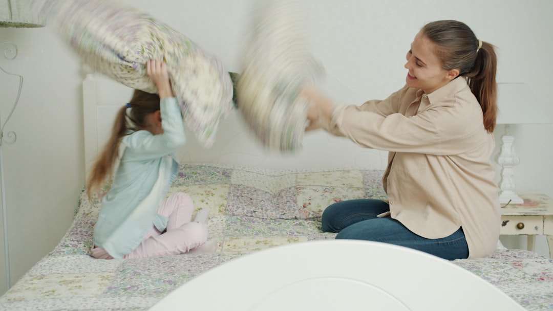 Mae E Filha Tendo Uma Briga De Travesseiros Na Cama dIK1Gh91rzc
